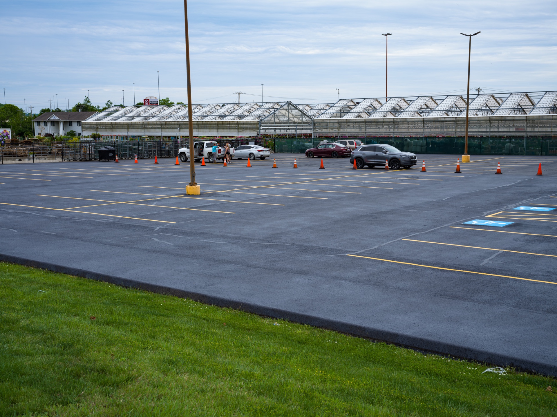 Freshly sealcoated commercial parking lot with sharp yellow line striping in Ohio